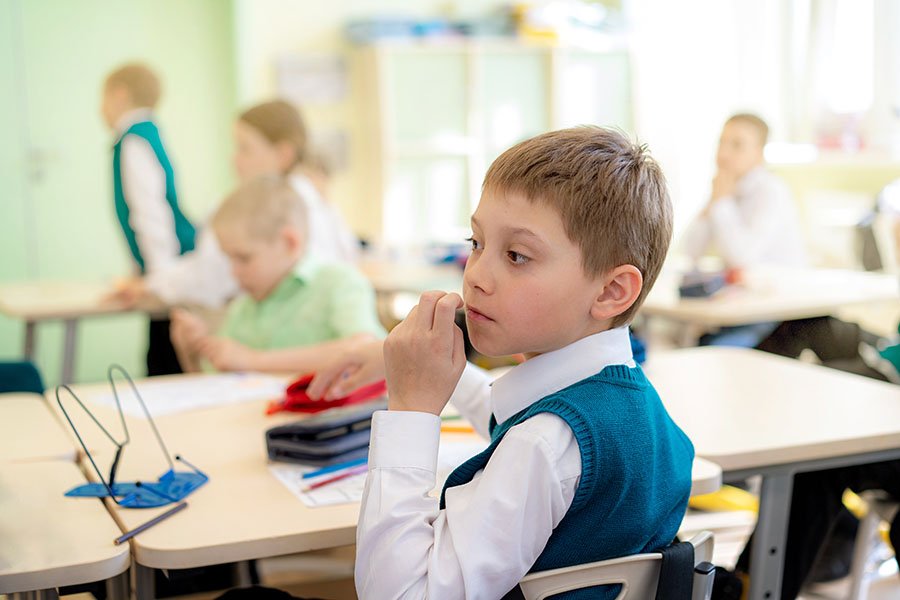 A pupil sitting at his desk in class